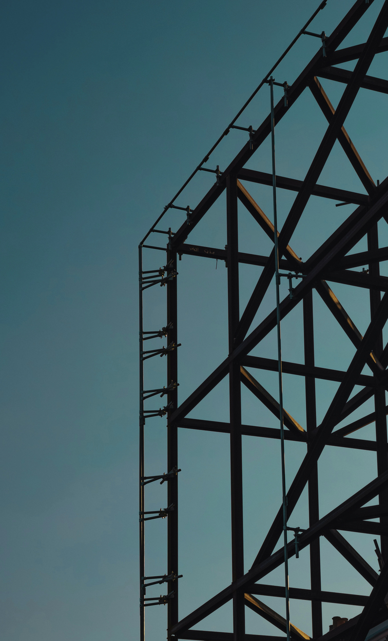 zoomed in photo on scaffolding against evening sky